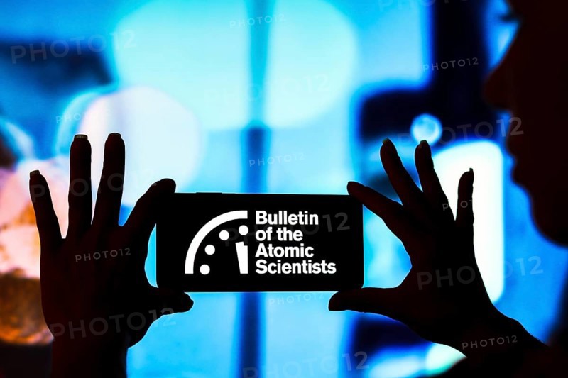 In this photo illustration, the Bulletin of the Atomic Scientists (Doomsday Clock) logo is displayed on a smartphone screen