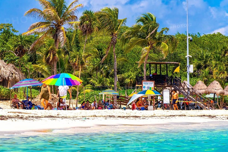 Playa del Carmen Quintana Roo Mexico 09. September 2023 Tropical mexican caribbean beach and sea with a lot of fun people sun loungers parasols turquoise water in Playa del Carmen Mexico