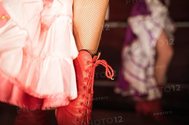 Detail of cancan dancer leg with red shoe