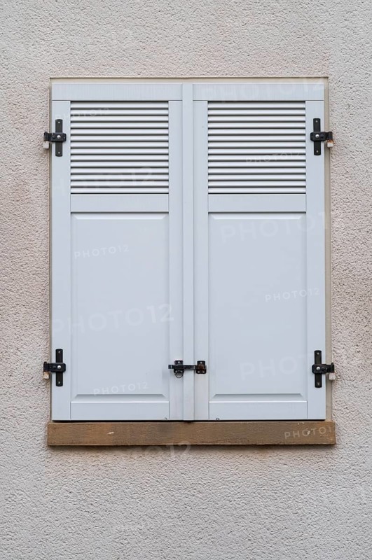 Windows with grey metal shutters