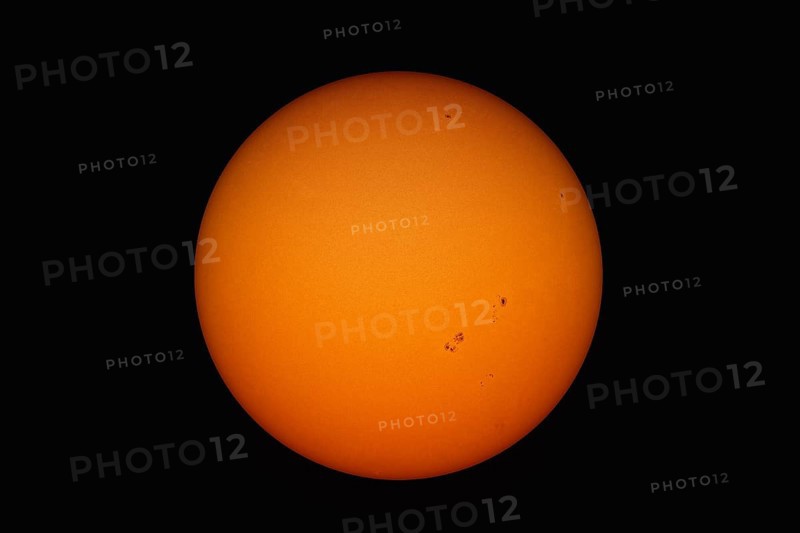 A view of the suns with spots and structure through a telescope