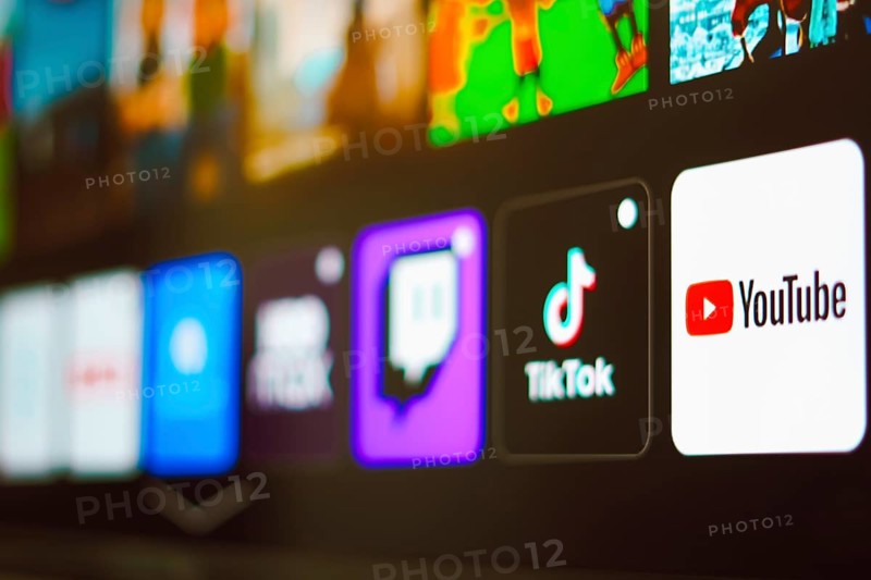 In this photo illustration the YouTube, TikTok and Twitch logo is displayed on a TV screen