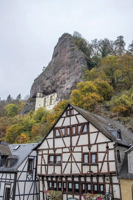 An old half-timbered town in autumn. A church was built into a rock here. Unique German architecture. Foggy landscape in the morning at the rock church, Idar-Oberstein, Rhineland-Palatinate, Germany, Europe
