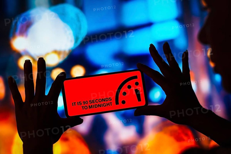 In this photo illustration, the Doomsday Clock at record 90 seconds to midnight is displayed on a smartphone screen