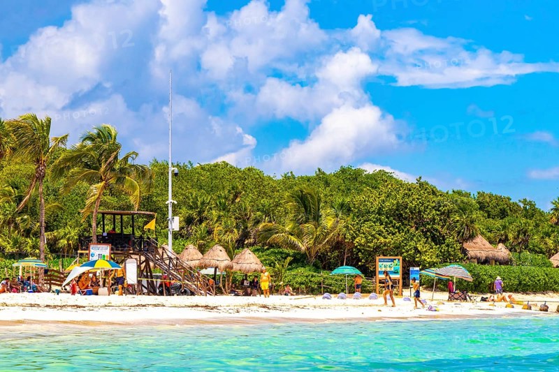 Playa del Carmen Quintana Roo Mexico 09. September 2023 Tropical mexican caribbean beach and sea with a lot of fun people sun loungers parasols turquoise water in Playa del Carmen Mexico