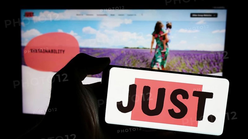 Stuttgart, Germany, 03-23-2024: Person holding smartphone with logo of British financial services company Just Group plc in front of website. Focus on phone display, Europe