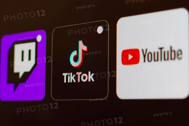 In this photo illustration the TikTok, Twitch and YouTube logo is displayed on a TV screen