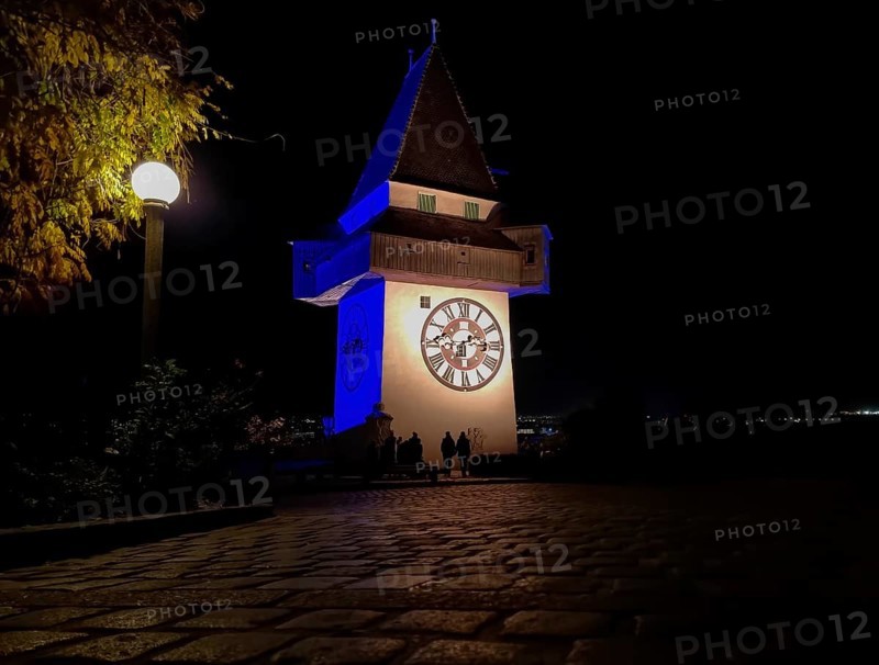 The famous Clock Tower (Grazer Uhrturm) on Shlossberg hill, Graz, Styria region, Austria, by night, Europe