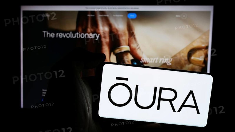 Stuttgart, Germany, 07-11-2024: Person holding mobile phone with logo of Finnish health technology company Oura Health Oy in front of business web page. Focus on phone display, Europe