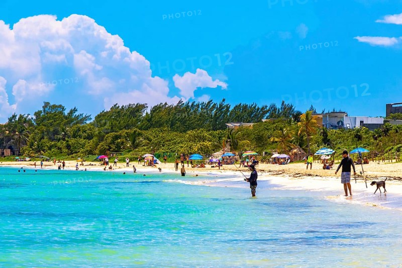 Playa del Carmen Quintana Roo Mexico 09. September 2023 Tropical mexican caribbean beach and sea with a lot of fun people sun loungers parasols turquoise water in Playa del Carmen Mexico