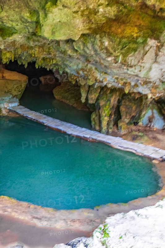 Amazing blue turquoise water and limestone cave sinkhole cenote at Santuario de los guerreros in Puerto Aventuras Quintana Roo Mexico
