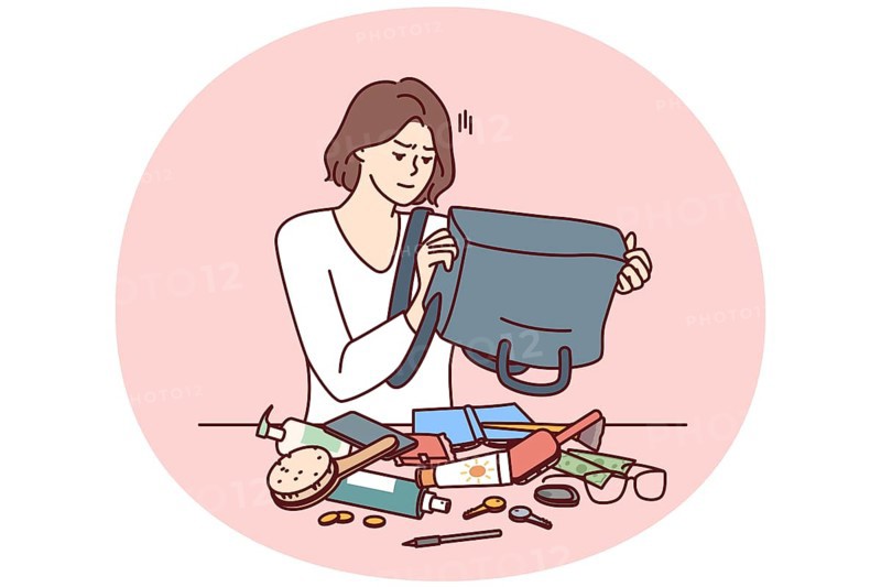 Puzzled woman shakes out contents of bag on table trying to find wallet with money or mobile phone. Girl is embarrassed because of mess in bag causing inconvenience and loss of wallet