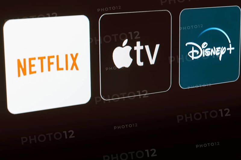 In this photo illustration the Netflix, Apple TV and Disney Plus logo is displayed on a TV screen