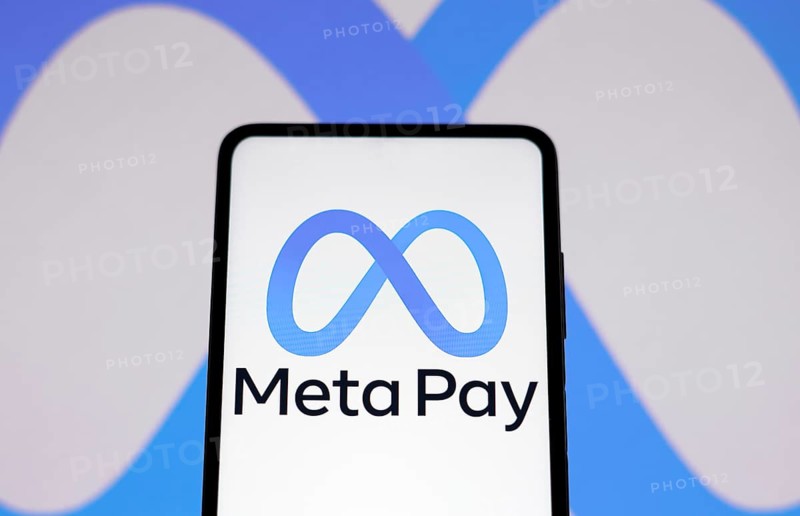 In this photo illustration the Meta Pay logo seen displayed on a smartphone and in the background the Meta Platforms logo