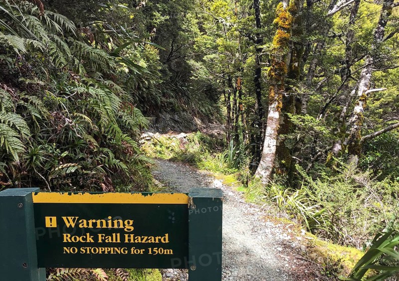 Warning sign about falling rock at famous Routeburn Track, South Island of New Zealand