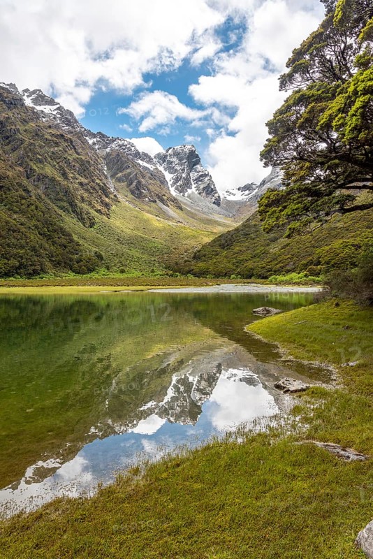 Tranquil mountain lake Mackenzie at the famous Routeburn Track, Fiordland National Park, South Island of New Zealand