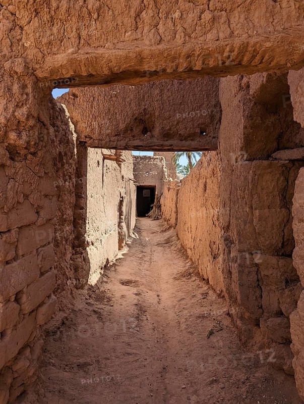 Typical abandoned alleyway surrounded by old clay walls in a little village somewhere in the Draa valley