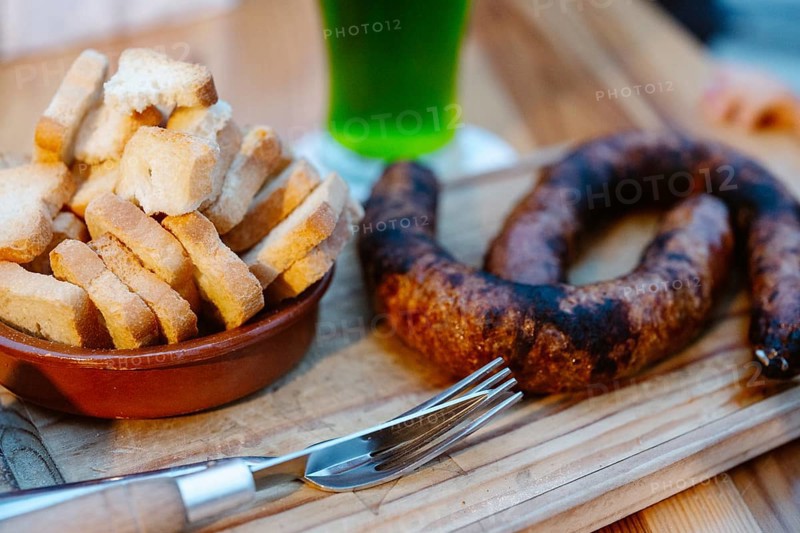 Typical Portuguese Appetizer with toasts and green beverage in the background in Albufeira, Algarve, Portugal, Europe