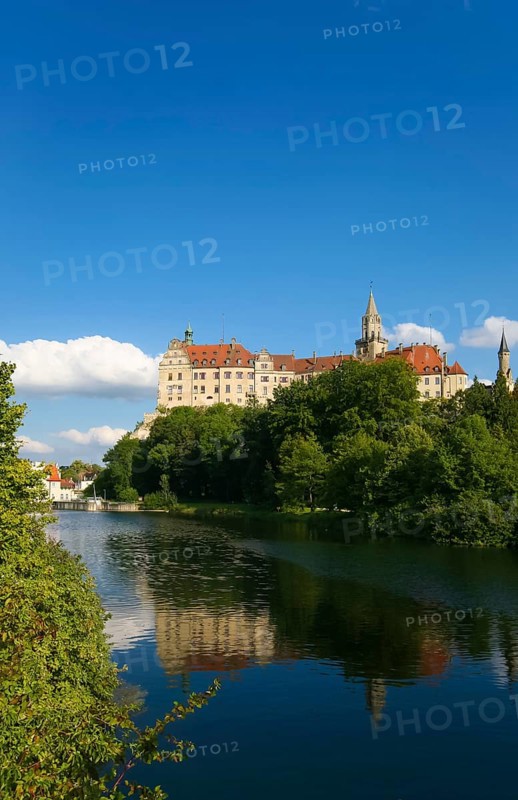 Hohenzollern Castle Sigmaringen, former princely residence and administrative centre of the Princes of Hohenzollern-Sigmaringen, city castle, architecture, historical building, west view, Danube, river, reflection in the water, blue sky, clouds, Sigmaringen, Upper Swabia, Baden-Württemberg, Germany, Europe