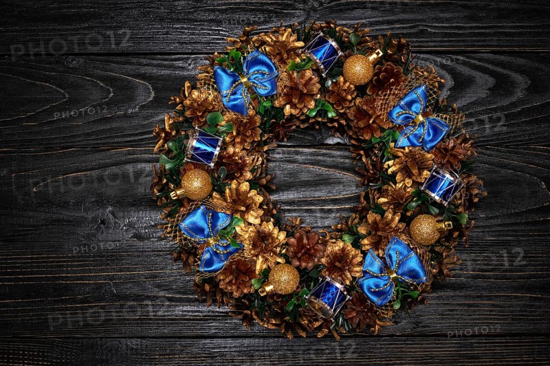 Christmas wreath on dark wooden background