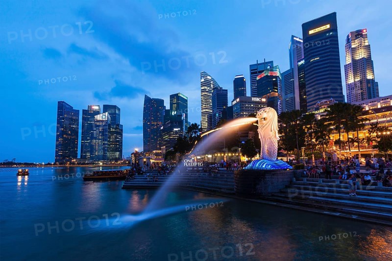 SINGAPORE, JANUARY 1, 2014: Night view of Singapore Merlion at Marina Bay against Singapore skyline. Merlion is a well-known tourist icon, mascot and national personification of Singapore