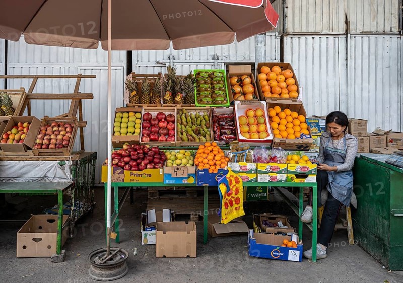 Fruit stall, woman selling fruit at the Osh bazaar, Bishkek, Kyrgyzstan, Asia
