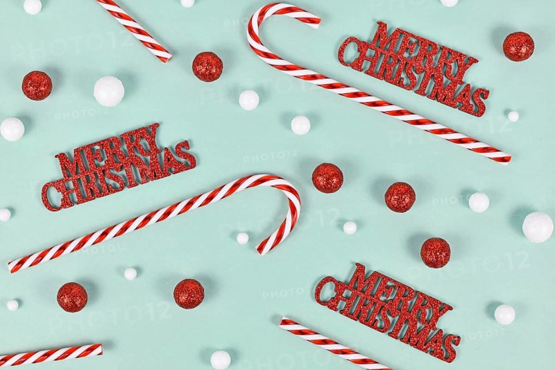 Christmas ornaments with 'Merry Christmas' text, candy canes and snowballs on mint green background