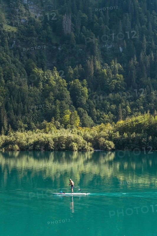 Stand-up paddler on Lake Klöntal, Canton Glarus, Switzerland, Europe