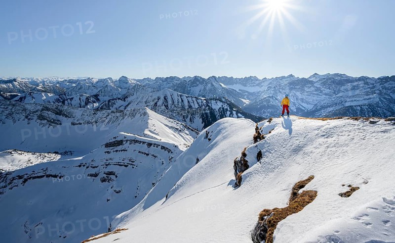 Ski tourers at the summit of Schafreuter, view of snowy mountain panorama, Karwendel, Tyrol, Austria, Europe