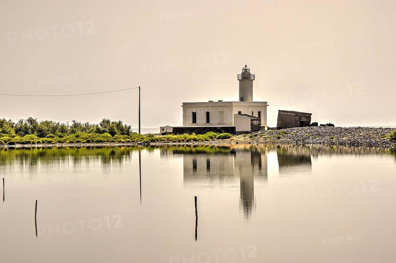 Faro di Punta Lingua, lighthouse, white sky, water reflection, Oasi naturale, Ex-Salina di Lingua, Lingua, south-eastern tip of the island, Salina, Aeolian Islands, Lipari Islands, Sicily. Italy