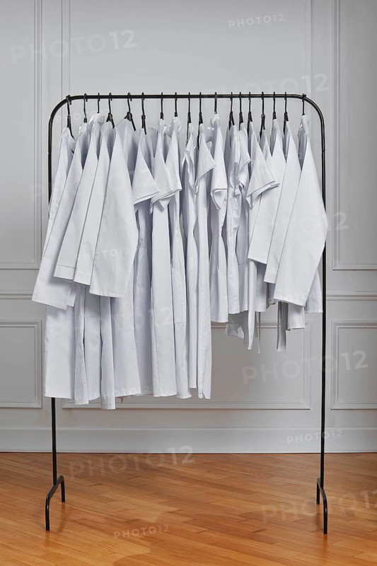 Medical clothes in row on floor hanger