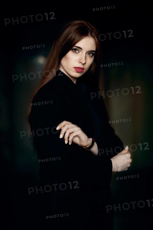 Low key portrait of beautiful girl with natural make up and red lips