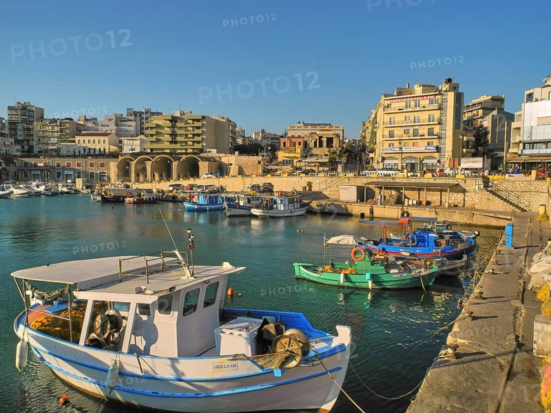 Morning light, fishing boats, old Venetian salt warehouse, houses, blue cloudless sky, harbour, Heraklion, capital, island of Crete, Greece, Europe