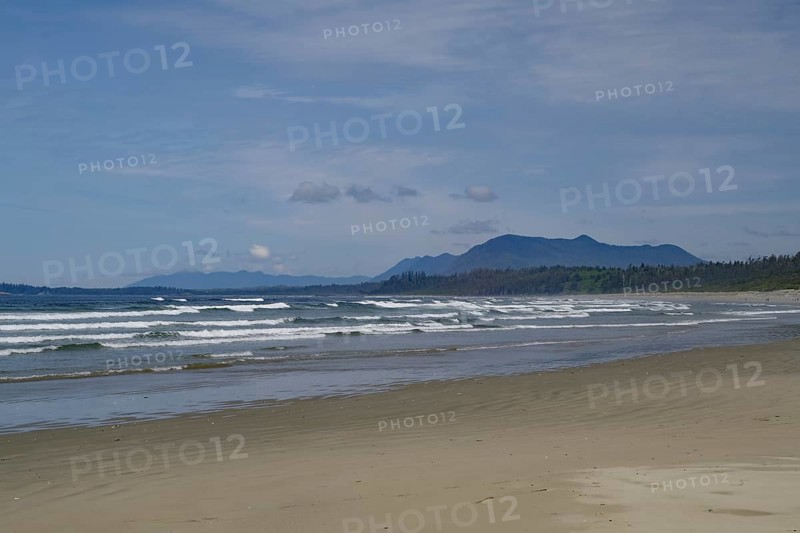 Endless empty sandy beach with swell and mountains in the background, Long Beach, Pacific Rim National Park, Vancouver Island, British Columbia