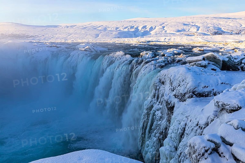 Godafoss waterfall in first morning sun, snow-covered landscape, Northern Iceland Eyestra, Iceland, Europe