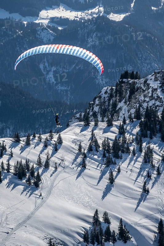 Mountains in winter, paraglider with skis on Sonntagshorn, Chiemgau Alps, Bavaria, Germany, Europe
