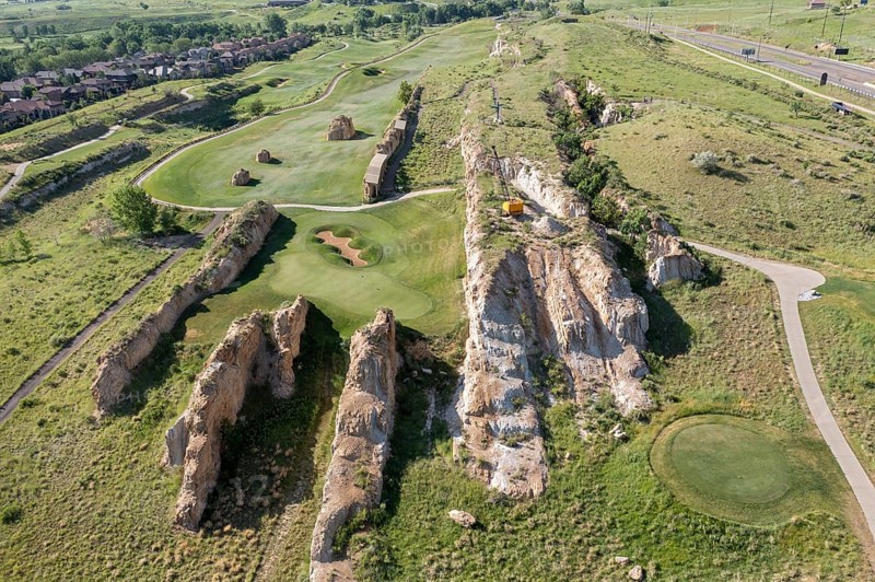 Golden, Colorado, Footprints of dinosaurs and traces of other animals and plants from the Late Cretaceous period are found along the Triceratops Trail in this former clay mine. The fossils were revealed on the hard sandstone fins after clay was removed between them. Visitors can explore the fossils or play golf at the Fossil Trace Golf Club. A dragline from the mining days remains atop one of the sandstone fins