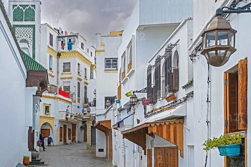 White houses and closed shops in shopping street on Friday in medina of the city Tangier, Tanger, Morocco, Africa