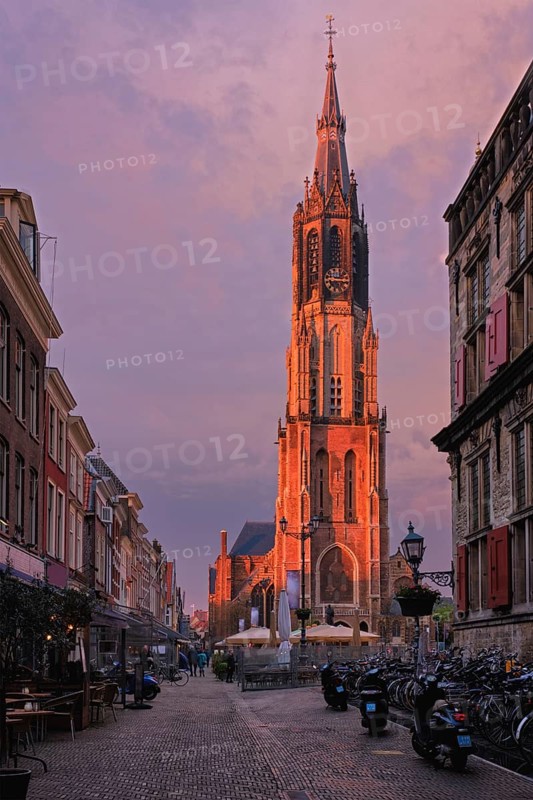 Delft, Netherlands, May 12, 2017: Nieuwe Kerk New Church protestant church on Delft Market Square Markt with dramatic sky on sunset. Delft, Netherlands