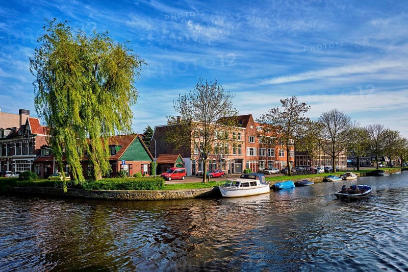 HAARLEM, NETHERLANDS, MAY 6, 2017: Boat in canal and houses. Harlem, Netherlands