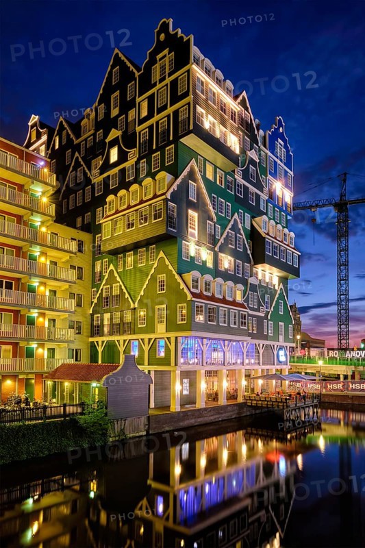 ZAANDAM, NETHERLANDS, MAY 21, 2018: Inntel Hotel in Zaandam illuminated at night. Design of 12-storey tall building opened in 2009 is the result of stacking a series of traditional Dutch houses