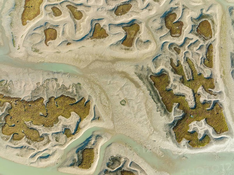 Network of channels and streams at low tide, in the marshland of the Bahía de Cádiz, aerial view, drone shot, Cádiz province, Andalusia, Spain, Europe