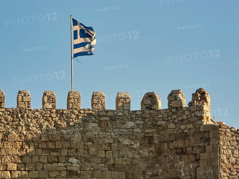 Venetian sea fortress, Koules, Morosini, battlements, Greek national flag, blue cloudless sky, harbour, Heraklion, capital, island of Crete, Greece, Europe