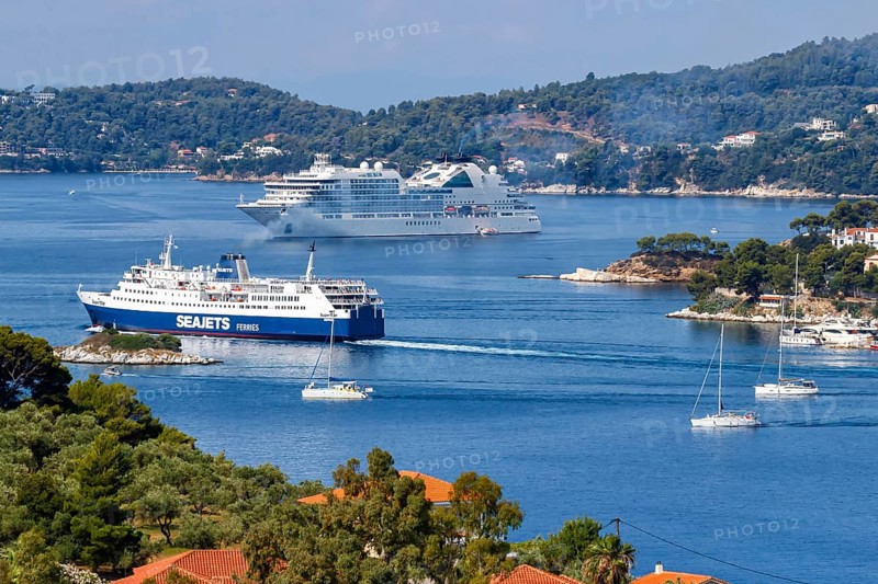 Cruise ship ferry and boats in the sea off the Mediterranean island of Skiathos, Greece, Europe
