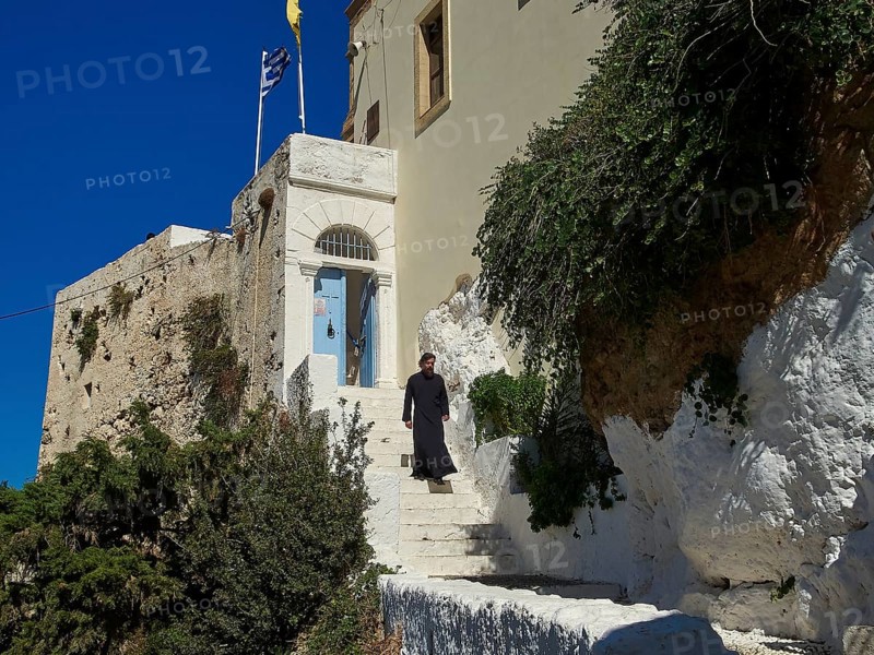 Stairs, young monk dressed in black on stairs, blue entrance door, Chrissoskalitissa, rock monastery, Orthodox monastery, southwest tip, Chania province, Crete, Greece, Europe