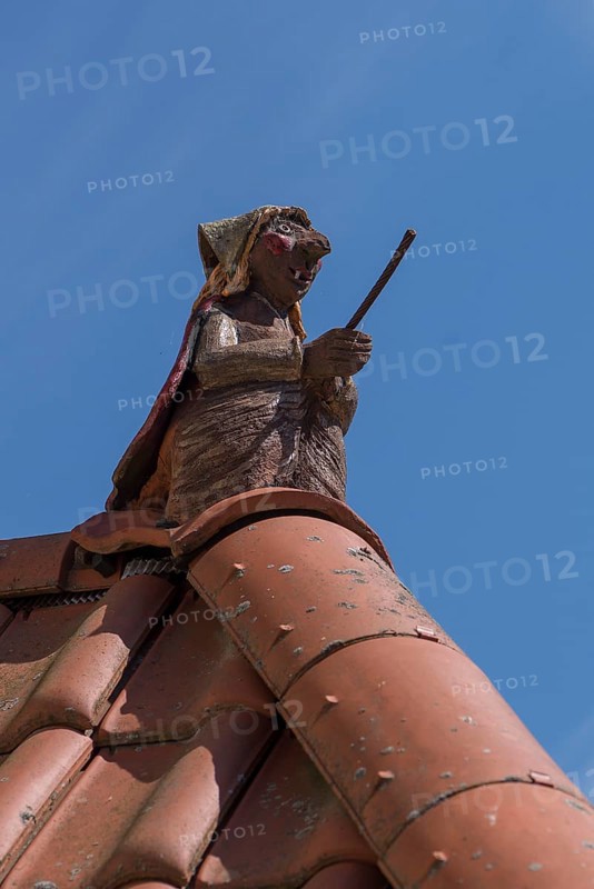 Figure of a witch on the roof ridge of a residential house, blue sky, Zeil am Main, Lower Franconia, Bavaria, Germany, Europe