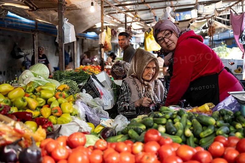 Old woman on a stall selling vegetables at the Osh Bazaar, Bishkek, Kyrgyzstan, Asia