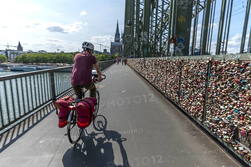 Cycling from a first-person perspective on a shared footpath and cycle path over the Hohenzollern Bridge in Cologne, North Rhine-Westphalia, Germany, Europe