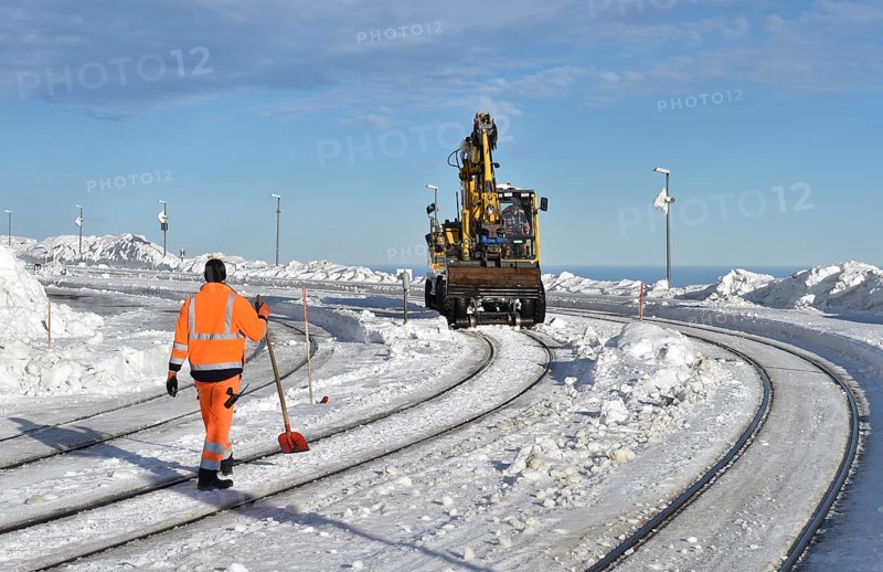 Two-way excavator clears the tracks of snow at Brocken railway station in the Harz mountains, Saxony-Anhalt, Germany, Europe