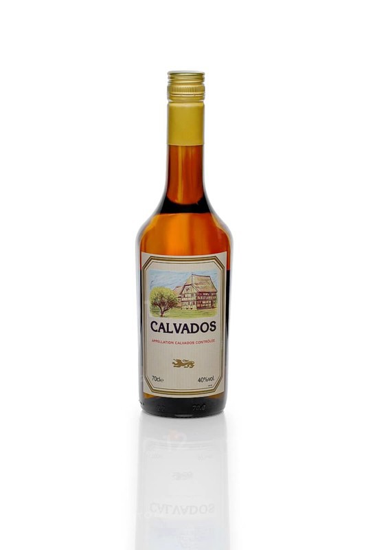 MINSK, BELARUS, March, 6, 2017: Bottle of Victor Fauconnier Calvados, apple French brandy with reflection on glass table isolated on white background